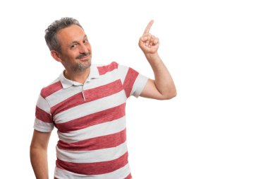 Beyaz stüdyo arka planında izole edilmiş boş telif alanına işaret eden sakallı, neşeli, yetişkin bir adam.