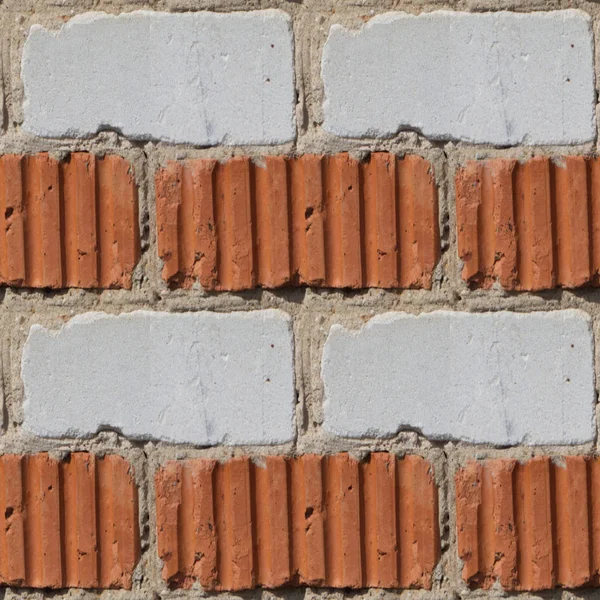 Ciment 和小石块之间的橙色和灰色或白色砖墙设计师无缝模式 — 图库照片
