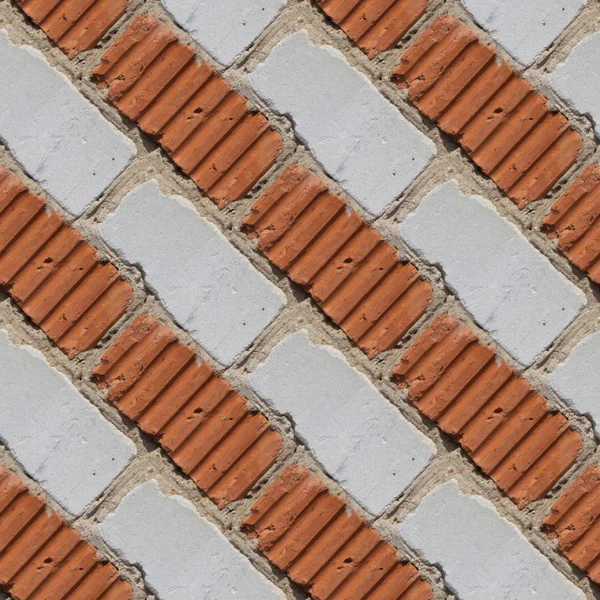 Seamless pattern for designers of orange and grey or white brick wall with fragment of ciment and little stones between tiles