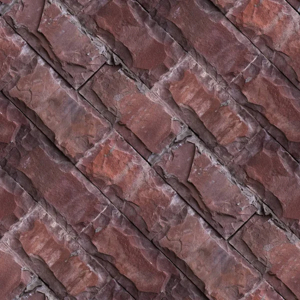 Doğal taş tuğlalardan kırmızı duvarın dikişsiz deseni.