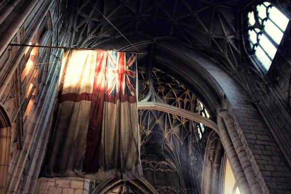 Old Britain flag inside gothic style cathedral — Stock Photo, Image