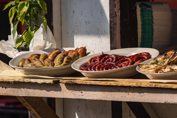 Culinary Buffet with healthy take away meal - grilled vegetables, fish and meat on the street food culinary market, festival, event.  Different types of delicious meat. Outdoor Cuisine. Street fair stand.