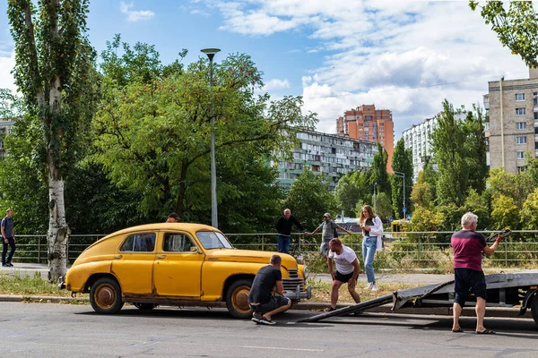 乌克兰基辅 2020年8月13日 复古汽车Gaz M20 Pobeda在城市街道上 1946年至1958年苏联生产的旧黄色生锈的汽车 男人们在研究另一场汽车故障 — 图库照片