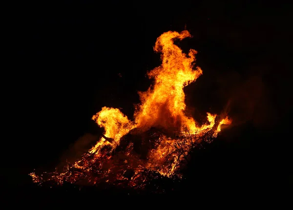 Large bonfire, burning and glowing with soft flames, sparkles fl