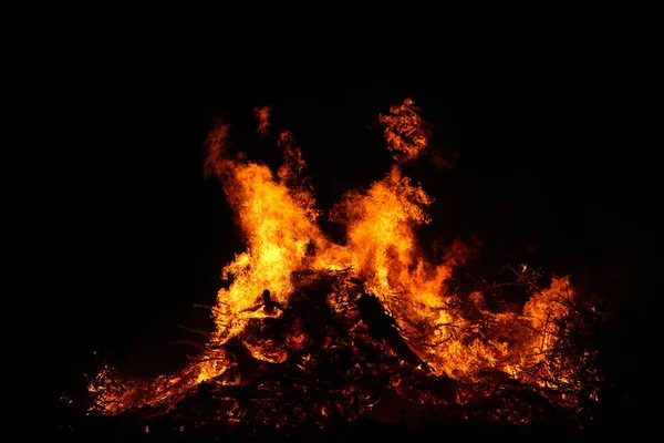 Large bonfire, burning and glowing with soft flames, sparkles fl