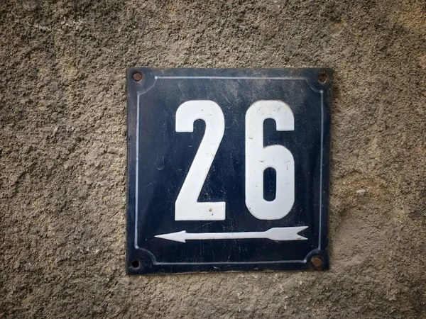 Vintage grunge square metal rusty plate of number of street address with number closeup