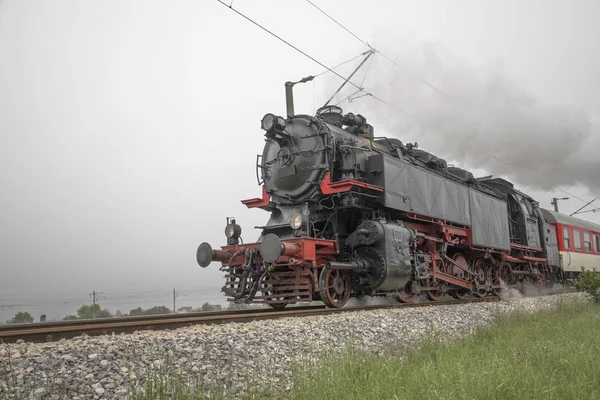 Retro vintage steam locomotive on rail tracks — Stock Photo, Image