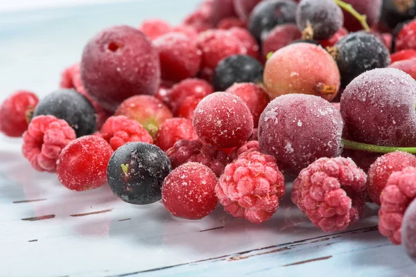 frozen fruit cherry, raspberry, blackcurrant in bags, close-up view from above.