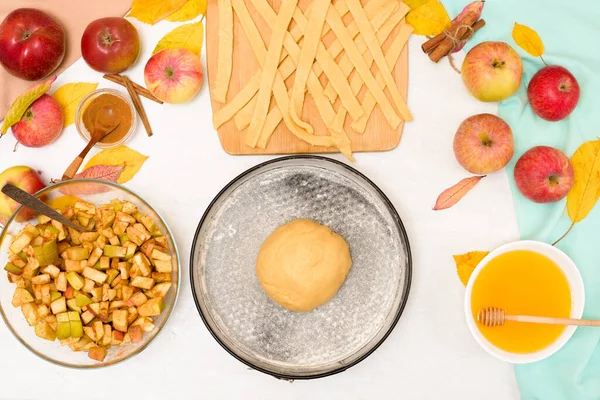 Autumn baking concept. step-by-step recipe for baking a traditional autumn Apple pie, copy the space on a light background. knead the dough and pour the apples into the dough.