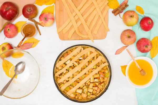 Autumn baking concept. step-by-step recipe for baking a traditional autumn Apple pie, copy the space on a light background. knead the dough and pour the apples into the dough.