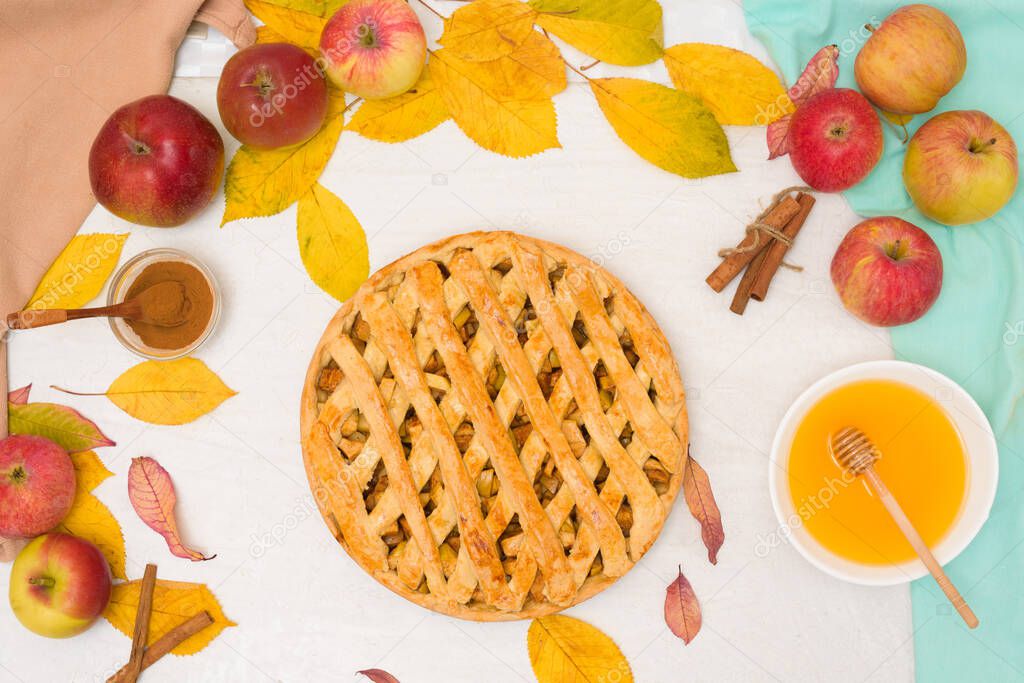 Autumn baking concept. Cooking baking traditional autumn Apple pie, light background copy space. homemade sweet dessert with apples and cinnamon.