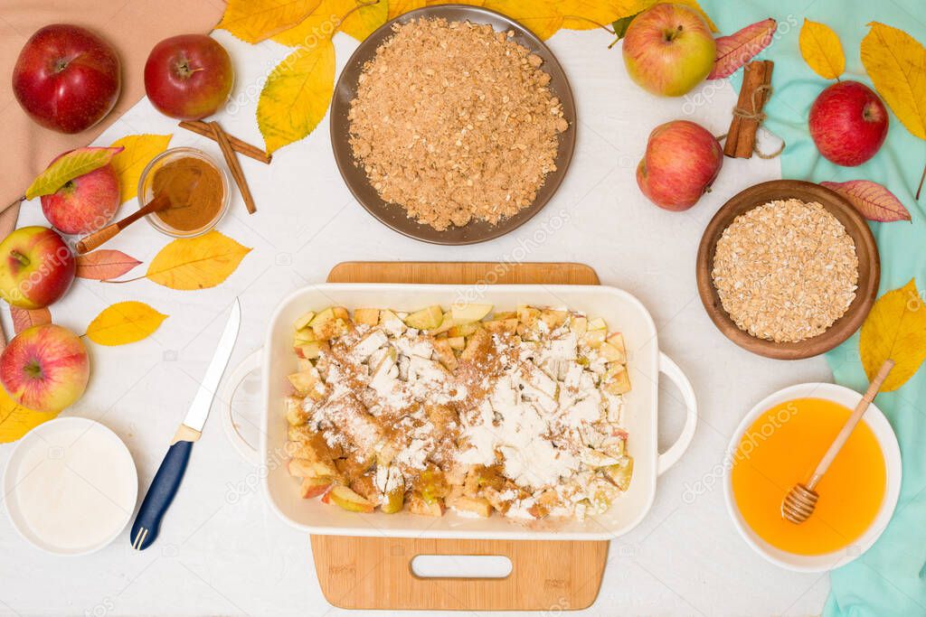 Apple crisp crumble, step-by-step recipe and mixing ingredients for home cooking on a light background top view. traditional autumn dessert with cinnamon and oatmeal, honey.