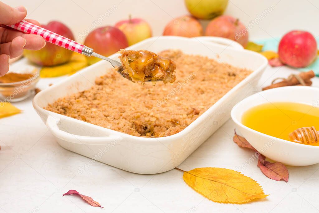 Apple crisp crumble for home cooking on a light background top view. traditional autumn dessert with cinnamon and oatmeal, honey