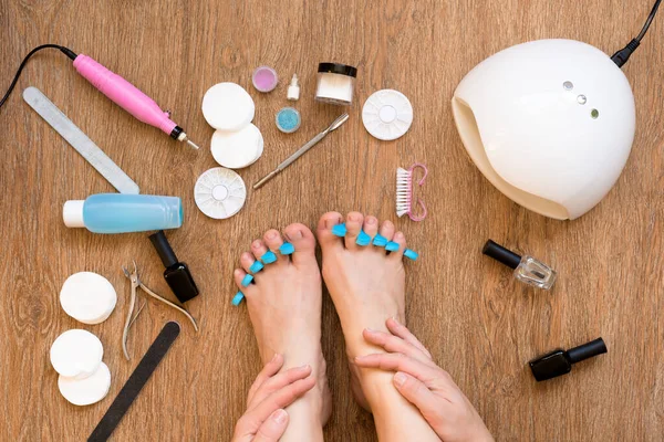 pedicure at home using nail Polish and UV lamps, nail files and scissors. taking care of yourself and your appearance from the comfort of your home. hygiene and cleanliness of the feet.