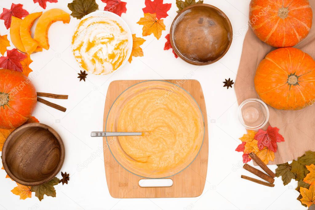 recipe and ingredients for cooking autumn pumpkin cupcakes . top view on a light background. the process of mixing flour, butter, eggs, sugar and pumpkin in a plate.