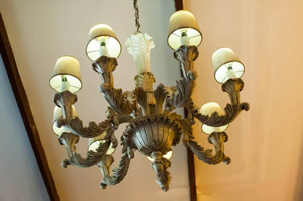A low-angle view of vintage chandelier on the ceiling