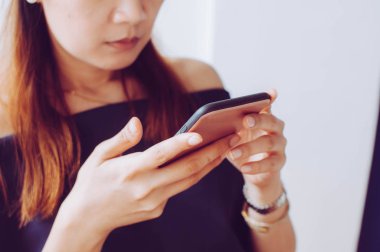 A young woman is using a mobile phone