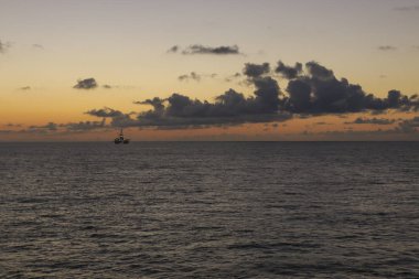 Petrol kuleleri ve offshore petrol platformlar üzerinde gündoğumu 