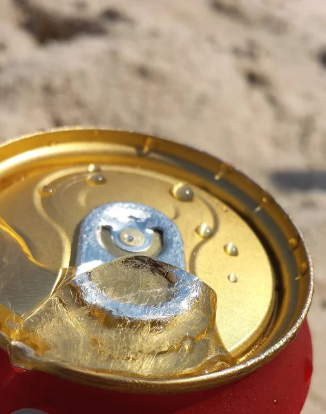 Can of beer very cold. Canned Beer with ice in the opening. Water drops and ice on a cans of beer.