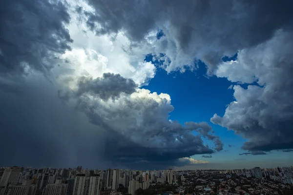 Dark and dramatic clouds of rain. Airplane taking off with storm clouds. Very heavy rain sky in the city of Sao Paulo, Brazil South America.