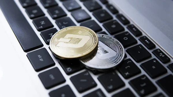 Silver and Gold Dash Cryptocurrency on laptop keyboard. Virtual money. Bussiness, commercial. Digital money and virtual crypto currency concept. Investment. Bussiness, commercial. Profit from mining.