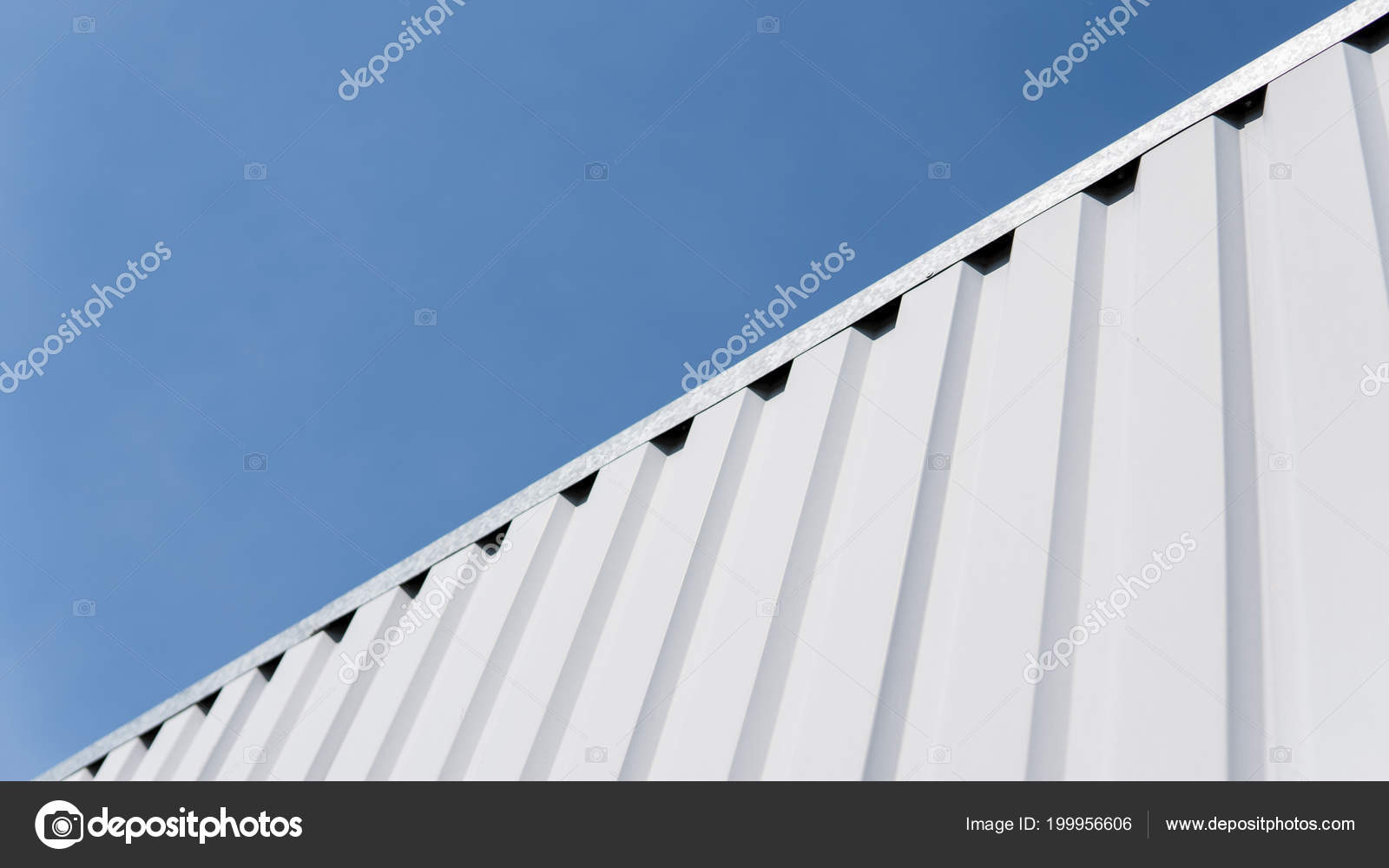 Metal white sheet for industrial building and construction on blue sky  background. Roof sheet metal or corrugated roofs of factory building or  warehouse. Stock Photo by ©volodymyrshtun 199956606