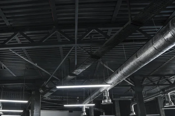 Sistema de ventilação no teto de grandes edifícios. Tubos de ventilação em material de isolamento de prata pendurado no teto dentro do novo edifício . — Fotografia de Stock