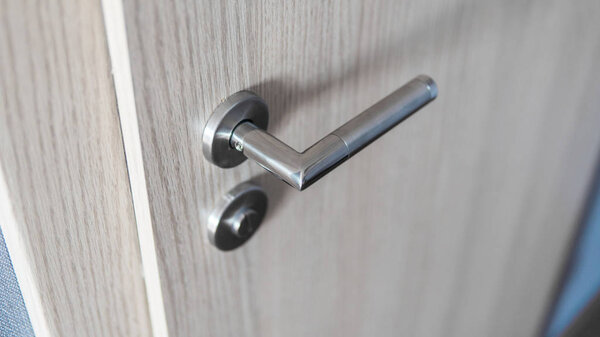 Door handle and inner lock on a wooden doors.