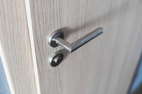 Door handle and inner lock on a wooden doors.