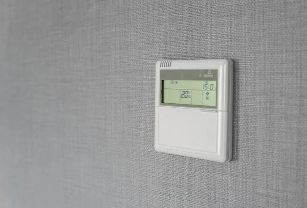 Wall display shows air temperature inside the apartment room. Smart home automation. Showing household consumptions related to temperature and heating.