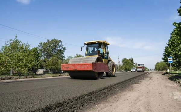 Heavy Vibration roller at asphalt pavement working on the new road construction site. Repairing.