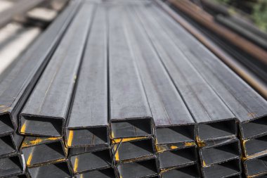 Yassı haddelenmiş boru metal profil metal ürünlerin depodaki paketlerine kare. İnşaat için metaller profilleri yıpranmış. Metal korozyon.