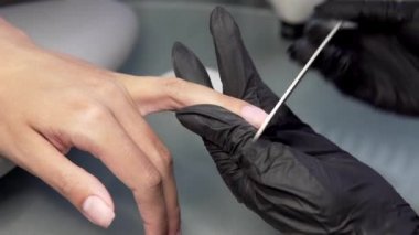 Şevval özçelik güzellik güzellik salonu bir manikür için çivi çubuğu biler. Parmak tırnak tedavisi, Bileme ve parlatma. Manikürcü eller yapmak kadın manikür ile tırnak makası tırnak Salon içinde.