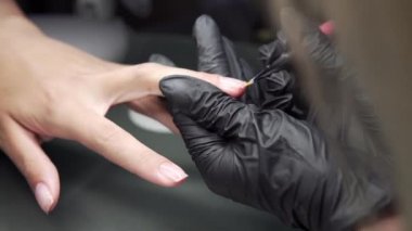 Manikürcü kurtarma yordamı pedikür ve uzantıları üzerinde tırnak salonu kız çivi çivi Tırnak salonu manikür bir güzellik uzmanı tarafından alma içinde closeup çekim bir kadının eller.