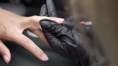 Manikürcü kurtarma yordamı pedikür ve uzantıları üzerinde tırnak salonu kız çivi çivi Tırnak salonu manikür bir güzellik uzmanı tarafından alma içinde closeup çekim bir kadının eller.