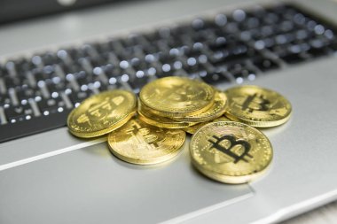 Bir sürü altın bitcoin sikke gümüş klavye laptop üzerinde. Sanal cryptocurrency kavramı. Bitcoins online iş araştırma. Bitcoins ticaret.