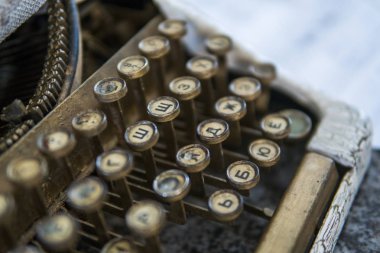 Close up view on an old dirty broken antique typewriter machine keys with Cyrillic symbols letters. clipart