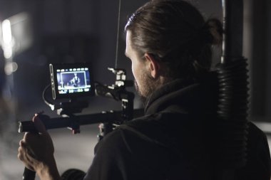 Profesyonel kameramanların kamera 3 eksenli gimbal üzerinde tutarak. Kameramanların Steadicam kullanarak. Pro ekipmanları sallayarak olmadan yüksek kaliteli video yapmak için yardımcı olur.