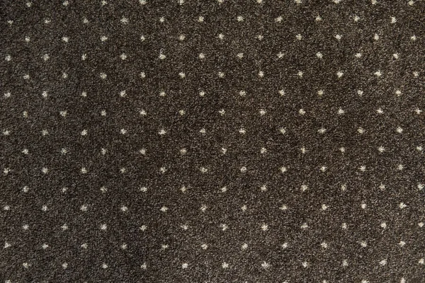 Alfombra marrón con una textura de puntos blancos. Tiro de alfombra interior a la luz del día . — Foto de Stock