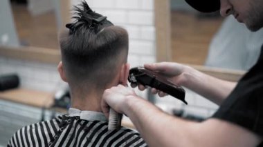 Erkek saç şekillendirme ile profesyonel düzeltici bir kuaför dükkanında yakından görmek. Kuaför Salonu Elektrik kesme makinesi ile kanununu mans. Saç bakım.