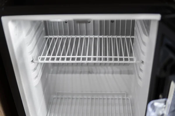 Empty open fridge with shelves, refrigerator. Empty cooler.