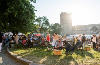 UKRAINE, LUTSK - 20 Haziran 2019: İnsanlar yemeklerini açık havada yiyorlar.