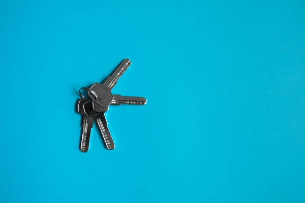 Door key lies on blue background. Set of keys. Bunch of keys. House key. New house concept. Rental and Selling.