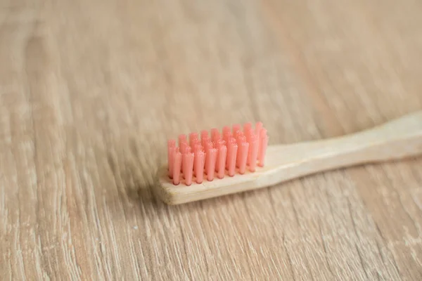 Eco-friendly bamboo toothbrush on a table. Zero-waste. Biodegradable toothbrush.