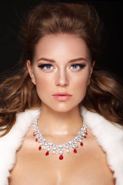 beyaz kürk ve kolye giyen parlak makyajlı çekici genç kadın