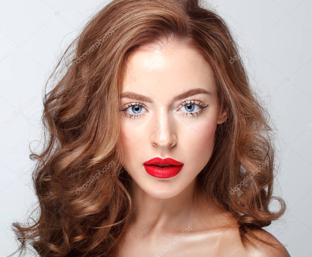 fashion portrait of beautiful brunette woman with blue eyes, bright red lips and long wavy hair