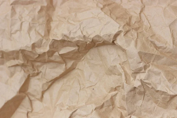 Brown wrinkle recycle paper background. Texture of crumpled paper. Texture of rumpled old paper close-up.