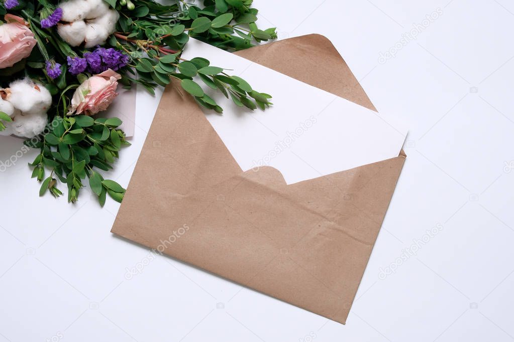 Mockup with postcard, flowers bouquet, kraft envelope.