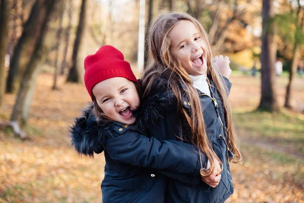 Two Happy Children Hugging Autumn Park Smiling Looking Camera Cute — Stock Photo, Image