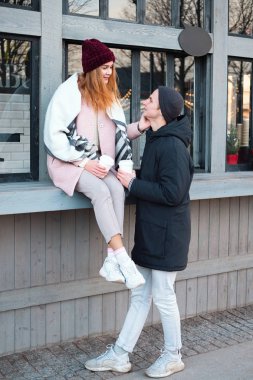 Oldukça soğuk kış hava, birlikte eğleniyor Sokak kafede kahve içme aşık şehvetli şık çift moda açık